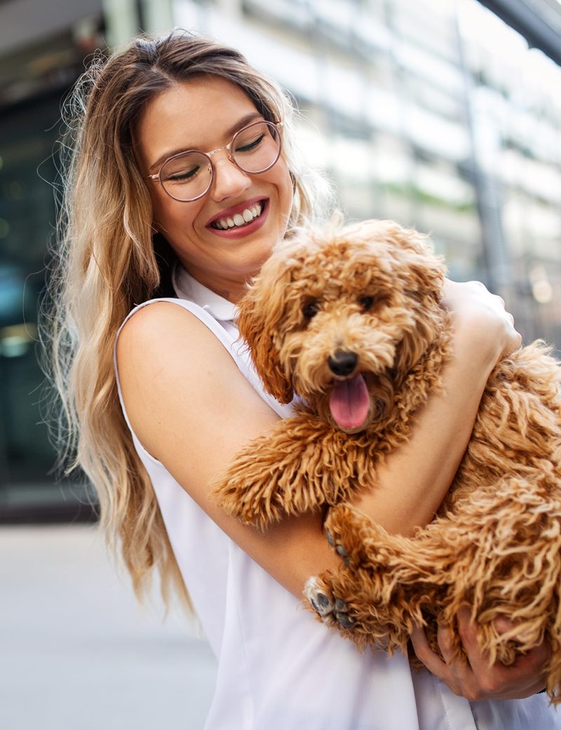 beauty-woman-with-her-dog-playing-outdoors-LN2XF4U.jpg